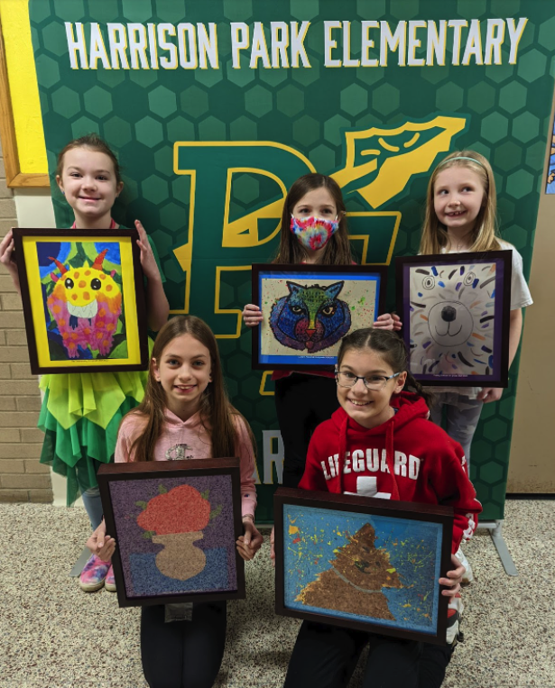 students hold their artwork