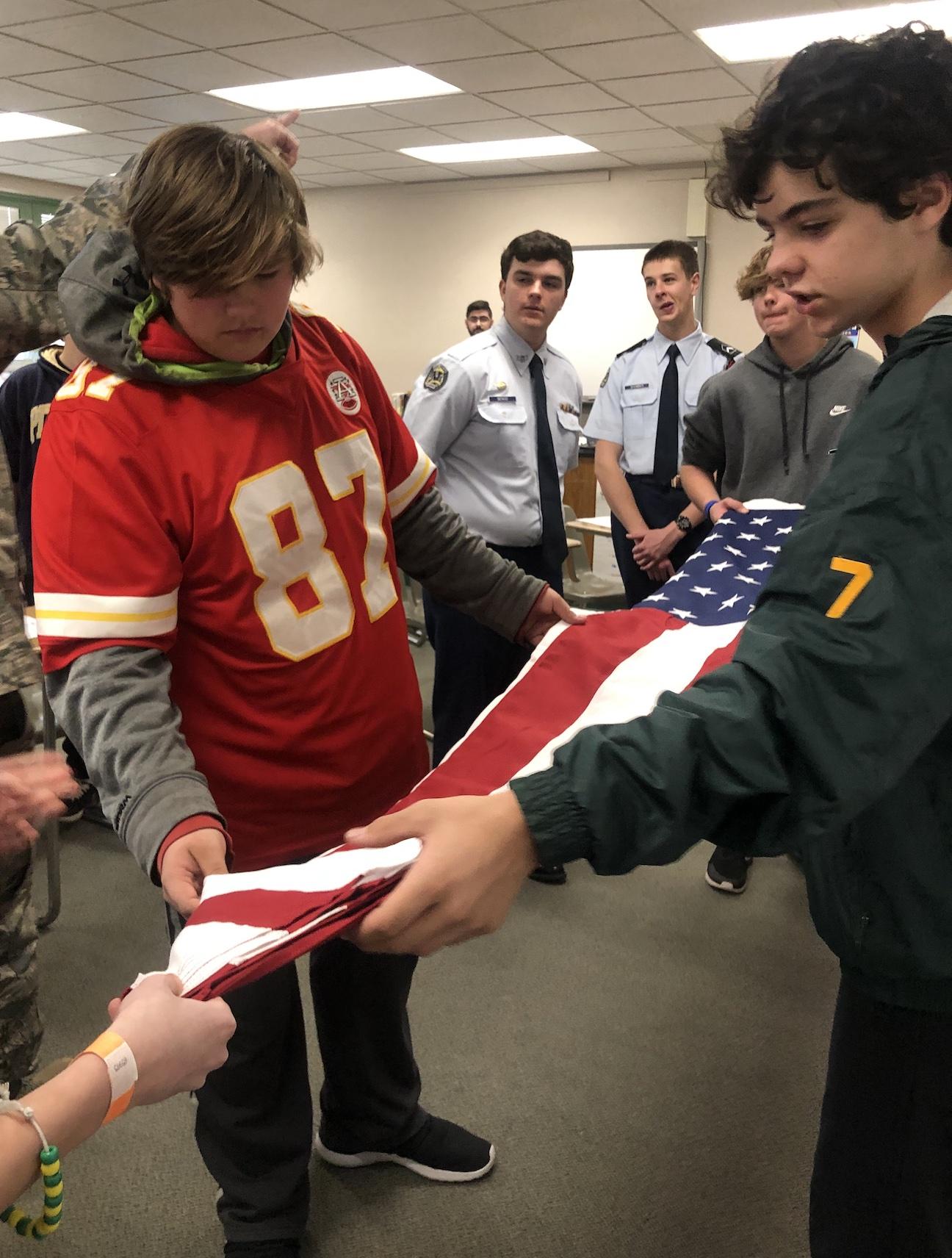 8th-graders Max Skaritka and Trey Muhitch practice folding the flag