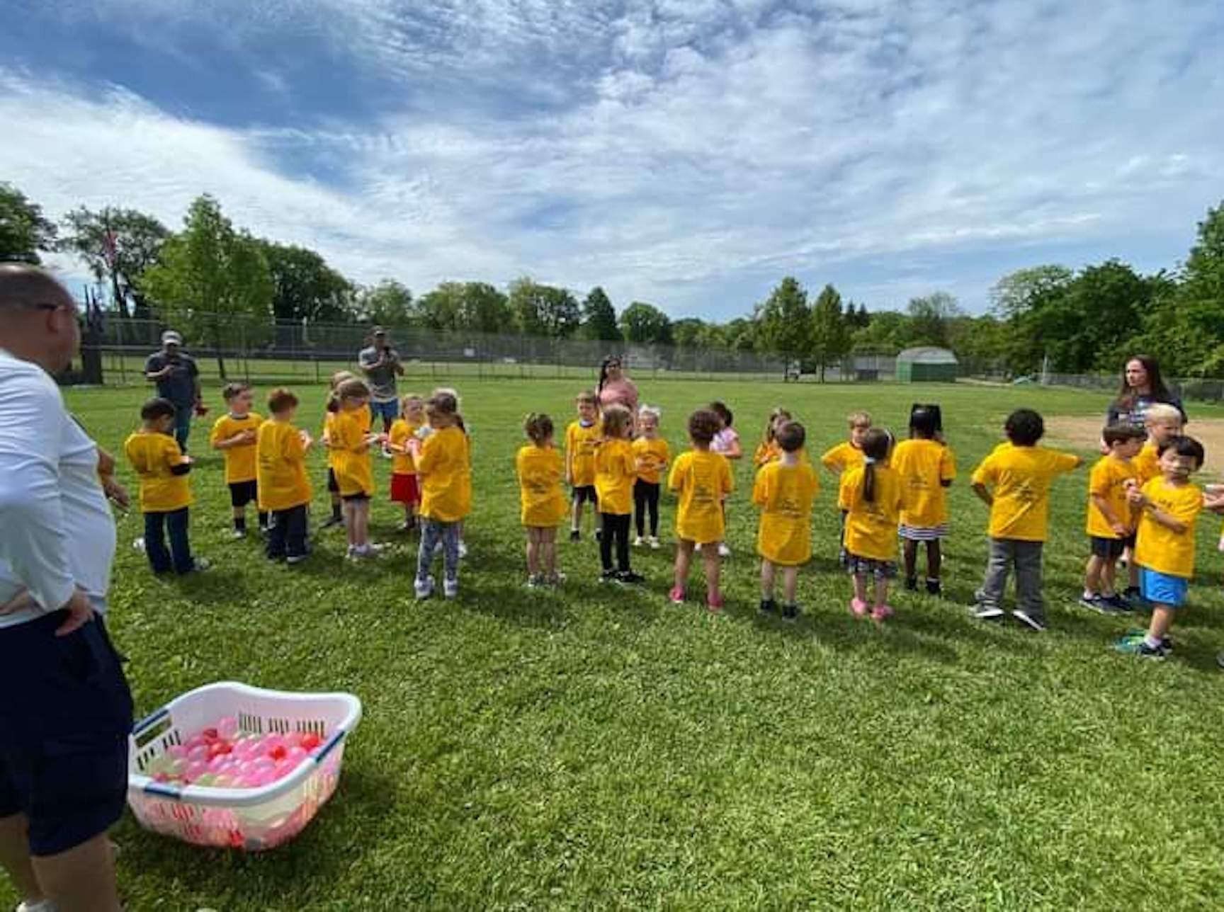 The students line up for a water balloon toss