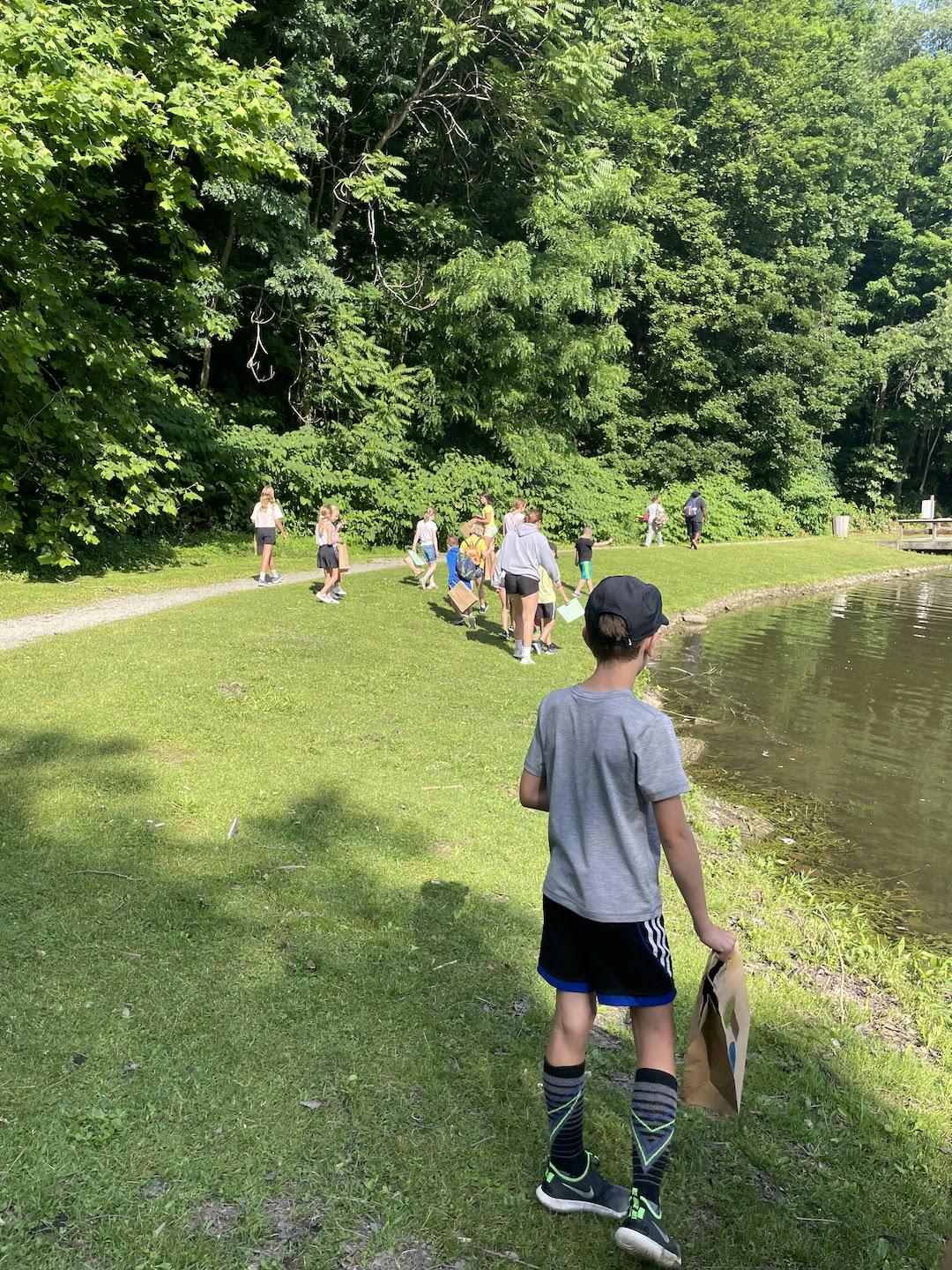 Campers enjoy a scavenger hunt around BY Pond
