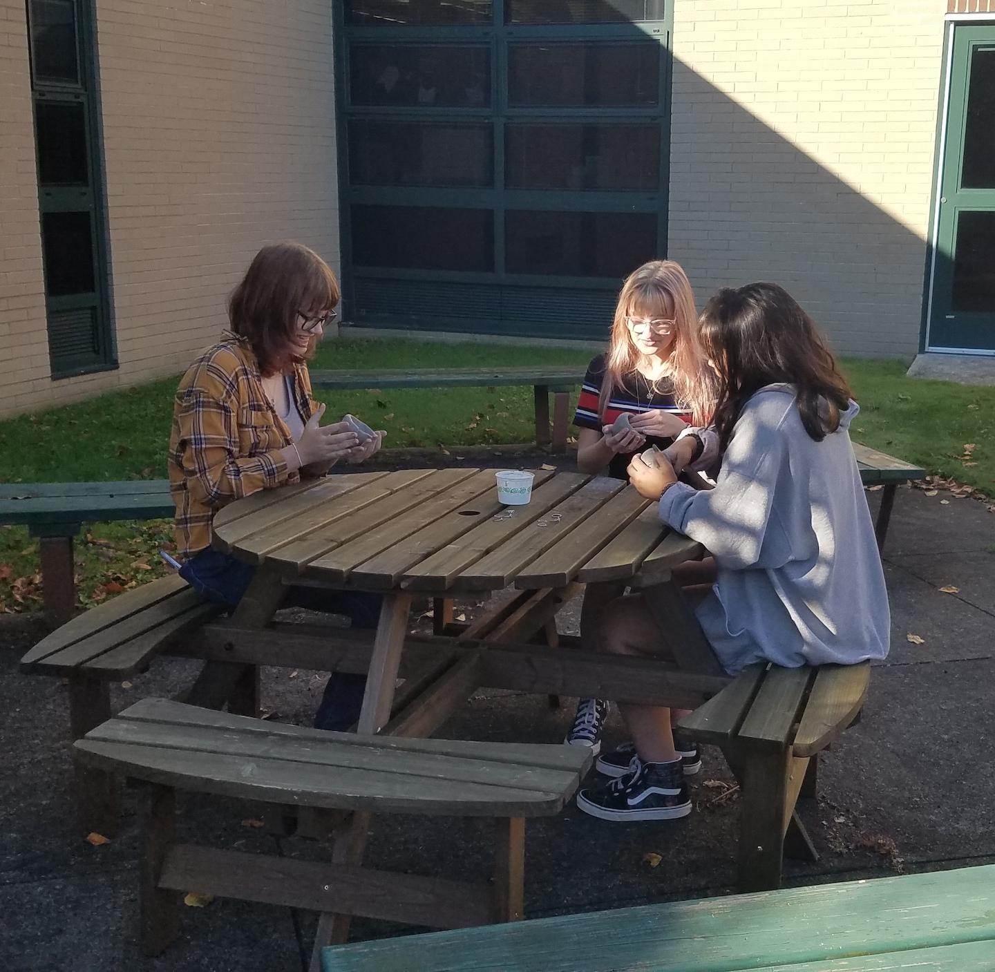 Mackenzie Miller, Sunni Spears and Symantha Lizotte enjoy art class in the fresh air
