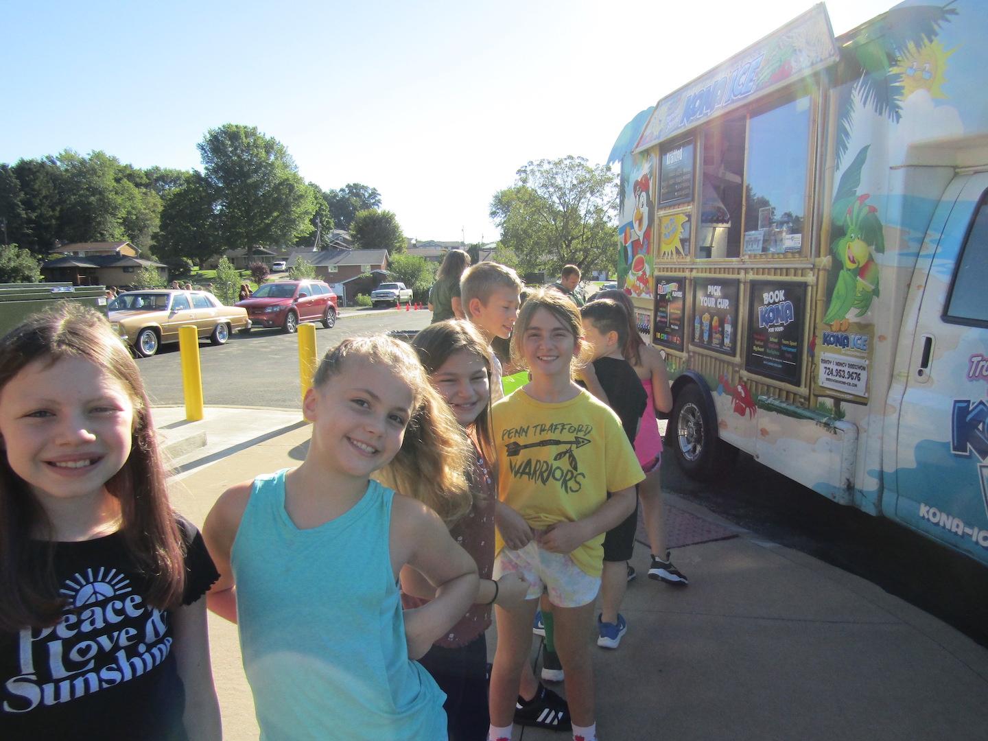 Fourth-graders line up at the Kona Ice truck