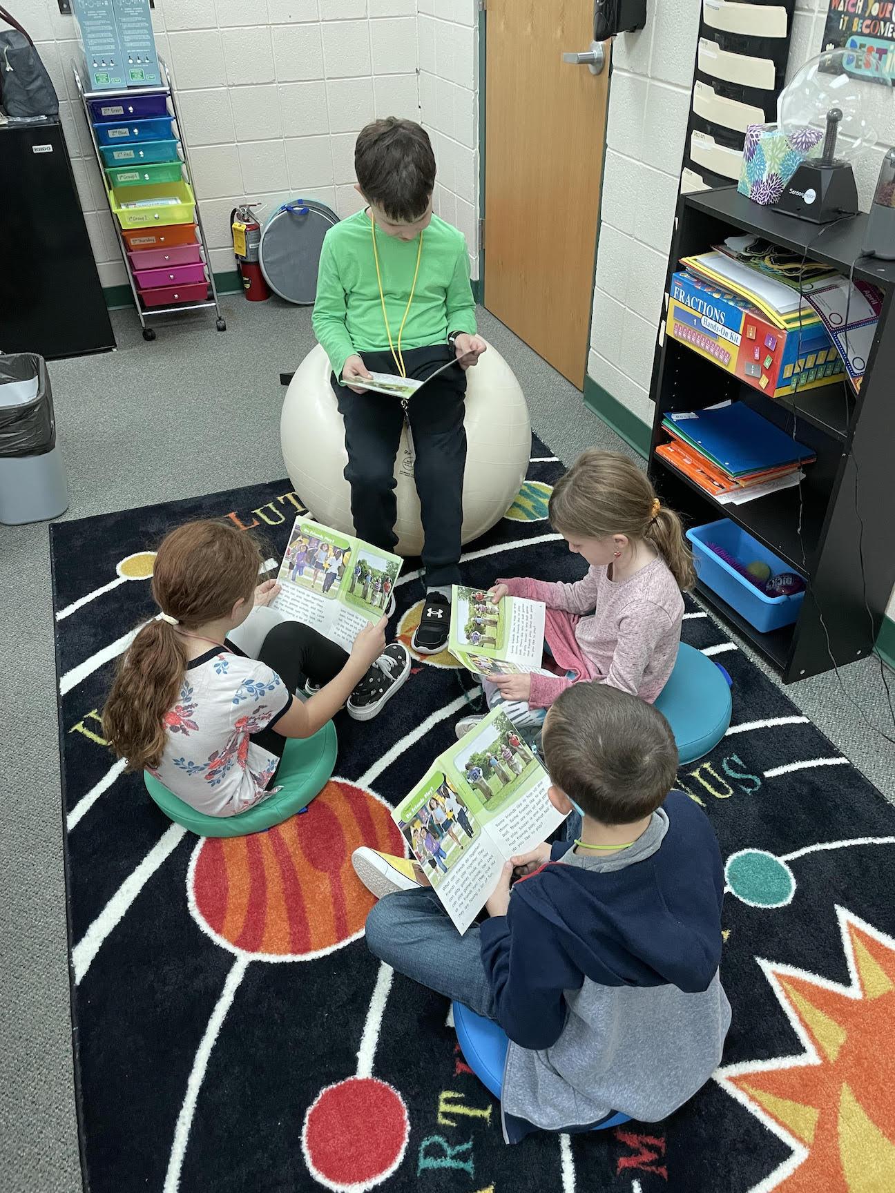 First-graders Lucas Ross, Gia Pecora, Sami Malloy, and Liam Tunstall enjoy the flexible seating