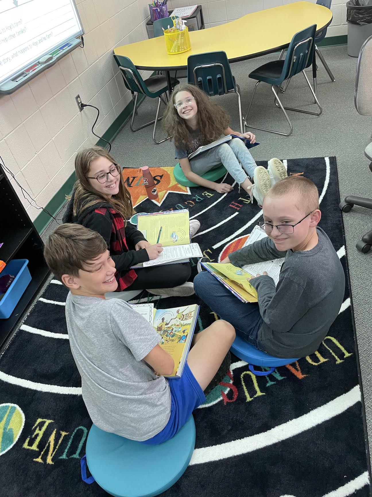 Fifth-graders Zach Sanders, London Weston, Hailey Corcoran, and Max Lenart use the cushions for a small reading group
