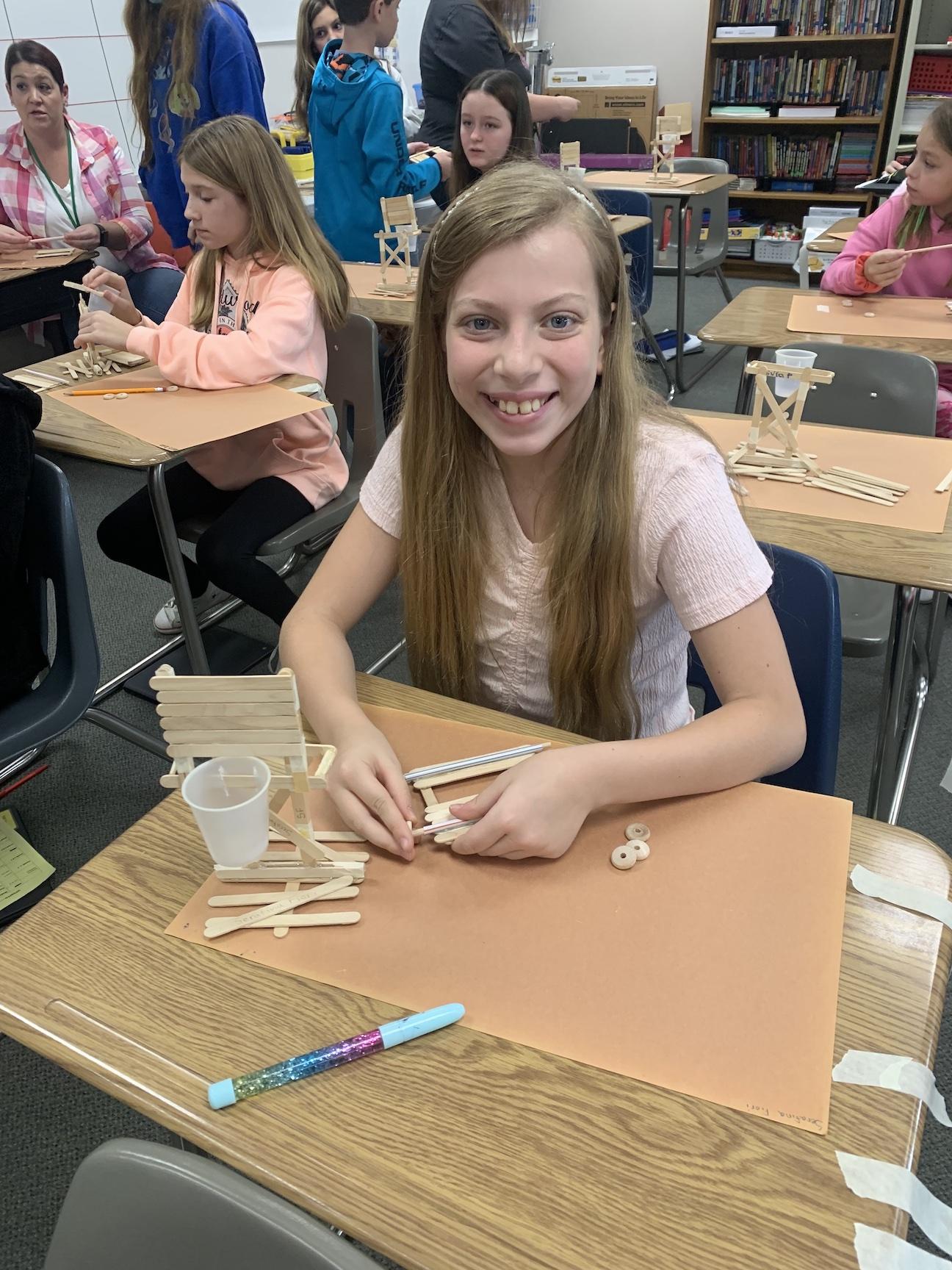 Serafina Fiori is all smiles as she masters building with popsicle sticks 