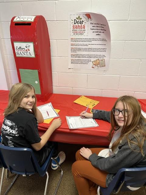 Gianna Duckworth and Savanna Klimek are busy at work writing their letters to Santa through the use of math prompts