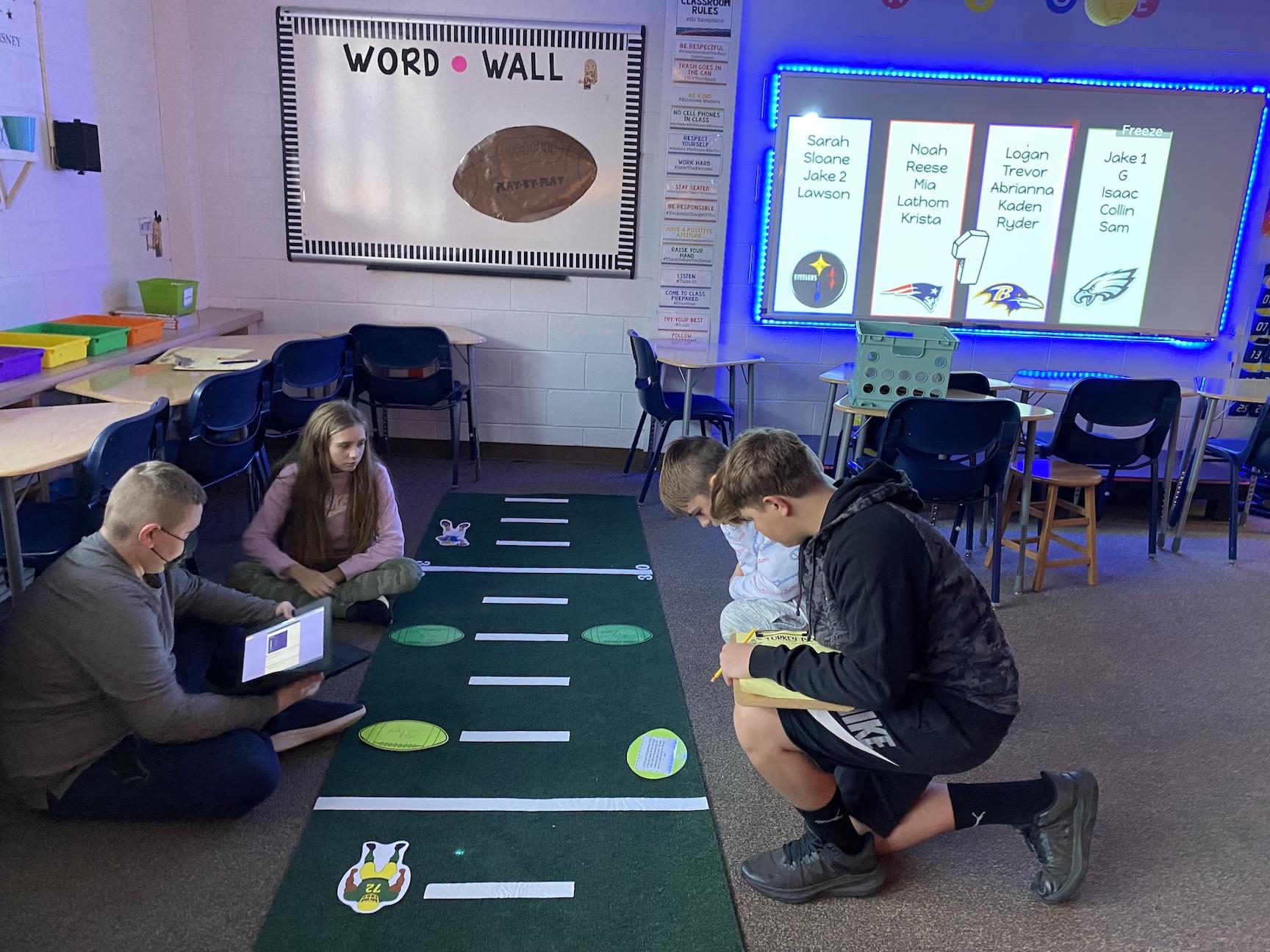 Trevor Seice, Abrianna Cycak, Logan Wisnick and Kaden Lipko use the football field to determine questions about positive and negative rational numbers