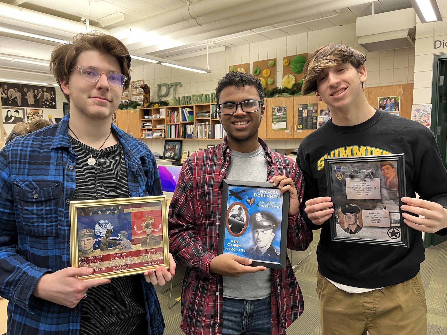 Art Extensions 3 students Zach Grabowski, Quintin Doberneck, and Gabriel Yant with their artwork