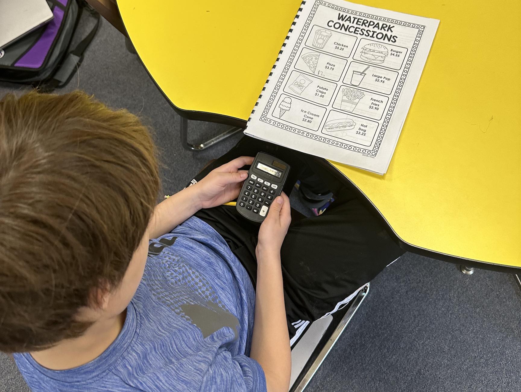 Gavin Kerstetter uses his calculator to complete math word problems