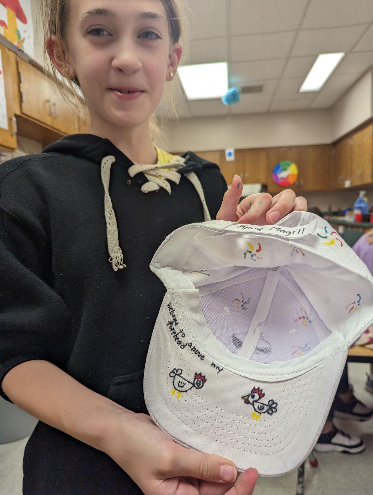Trafford 4th-grader Fionnuala Magill shares her hat art