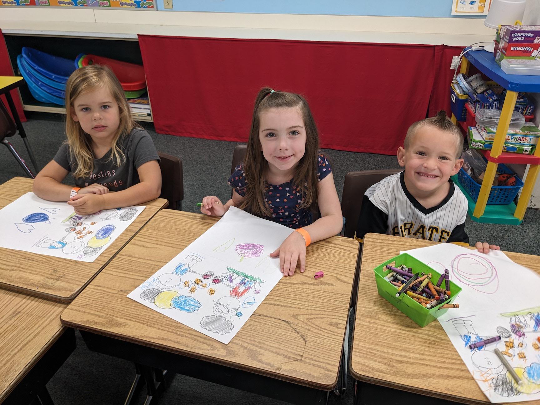 Rising kindergarteners Della Kasabian, Isla Scott, and Murphy Nutt enjoyed coloring and listening to stories about manners