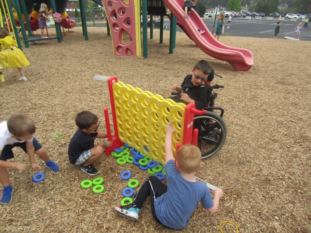 Kindergartener Nikolas Hoffer enjoys some playground time with his friends