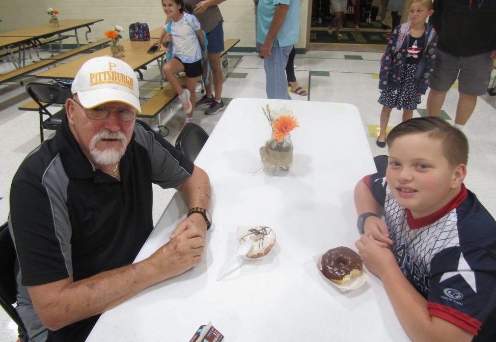 Cameron Kitchen (grade 4) welcomes his grandfather to breakfast