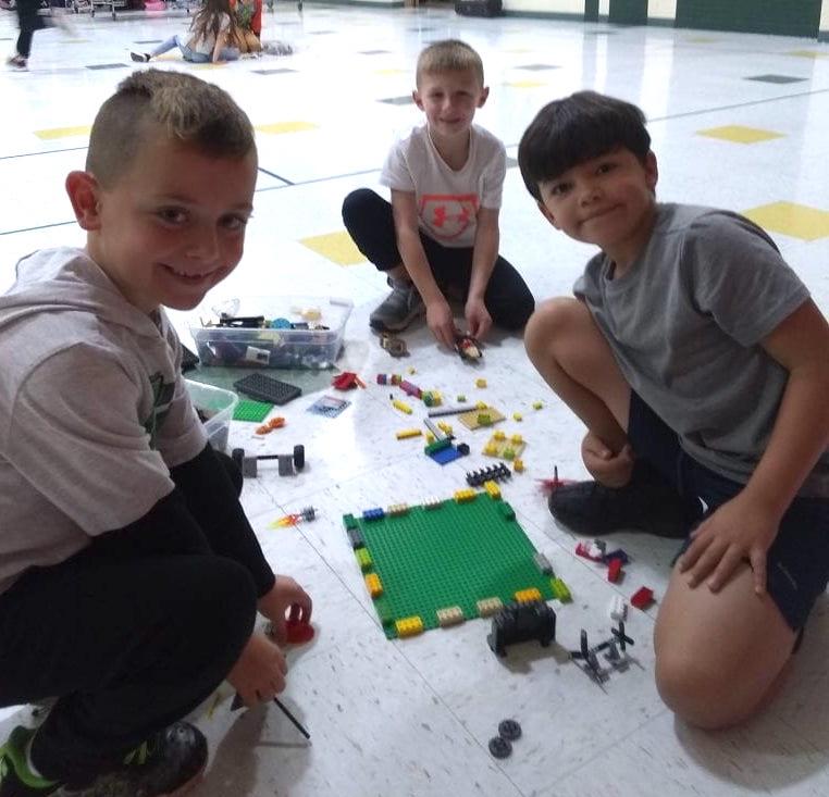 First-grader Garret Gnesda builds with second-graders Luke Bradley and Maison Cooley