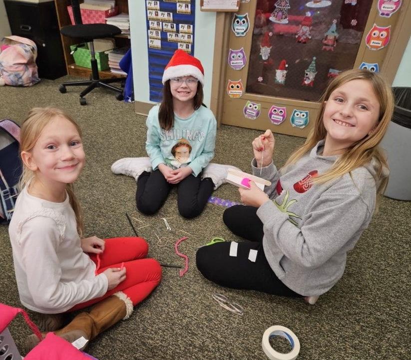 3rd-graders Ari Cianciotti, Abby Strasser, and Josie Probst begin work on their sleigh