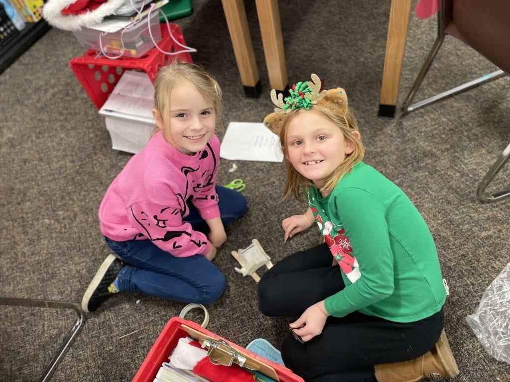 2nd-graders Alyona Krowchak and Juna Rodgers put the finishing touches on their project