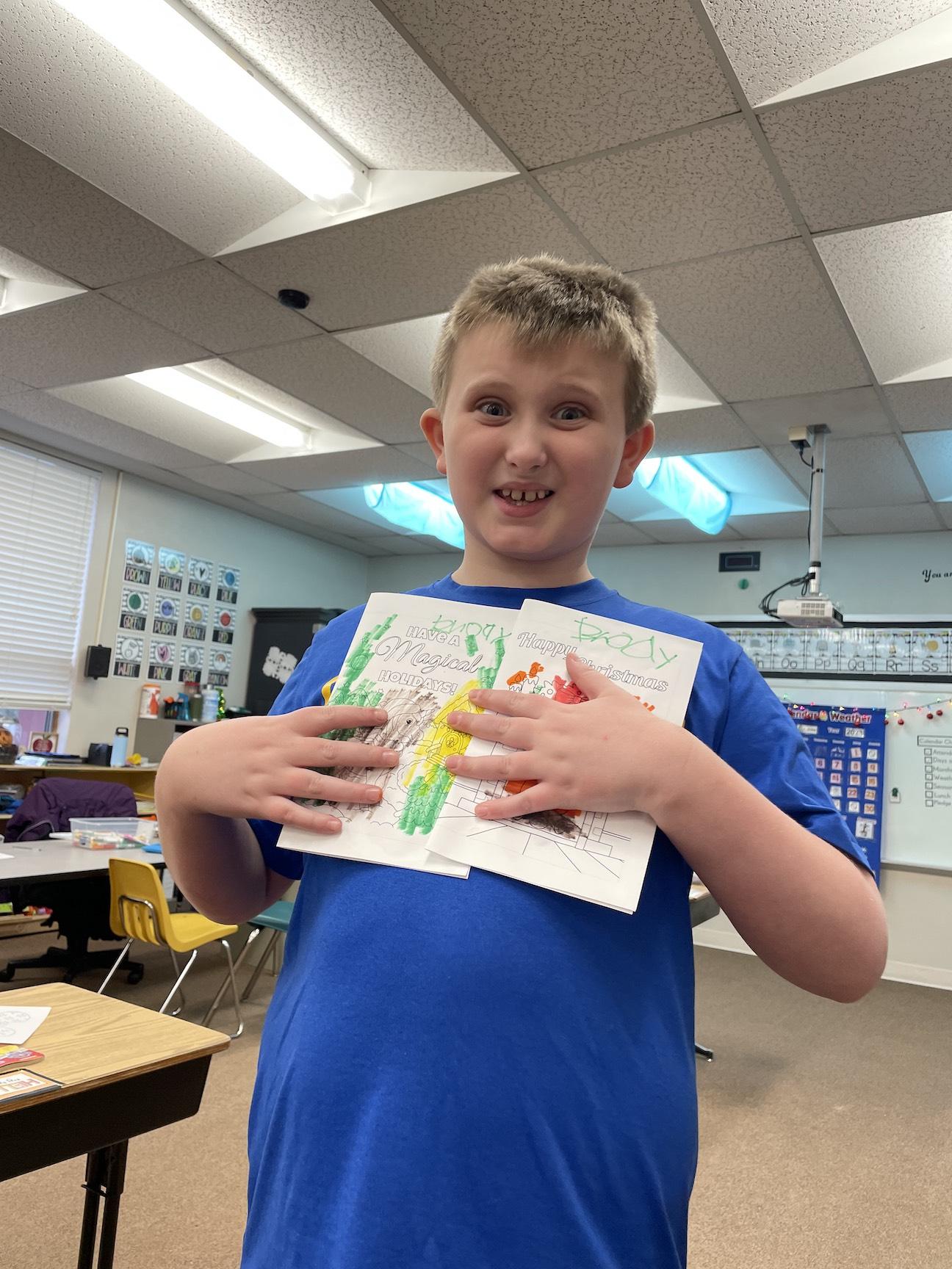 Brody Fuller, grade 3, holds cards the class decorated 