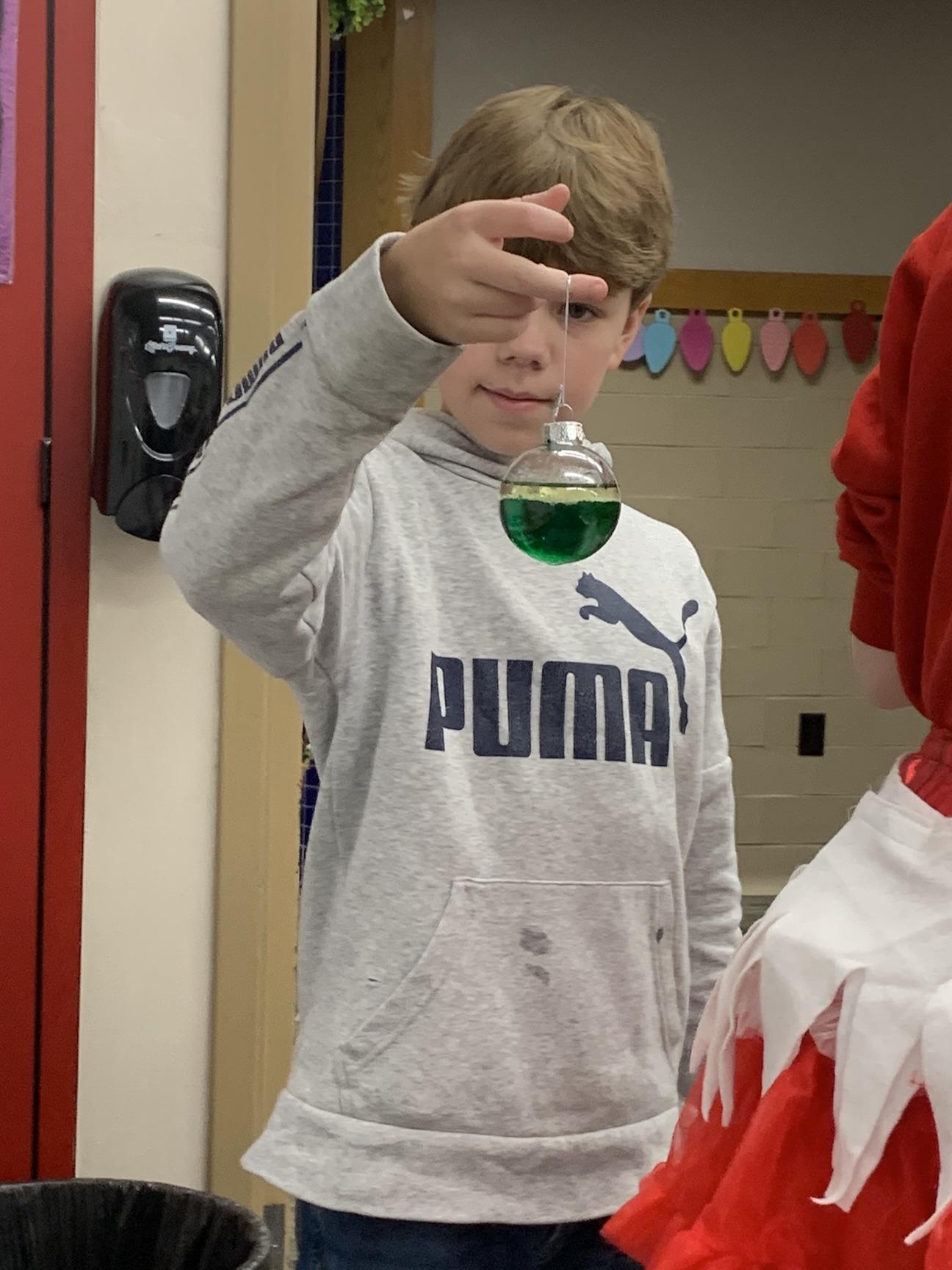 5th-grader Vincent Tomasic watches as his ornament bubbles