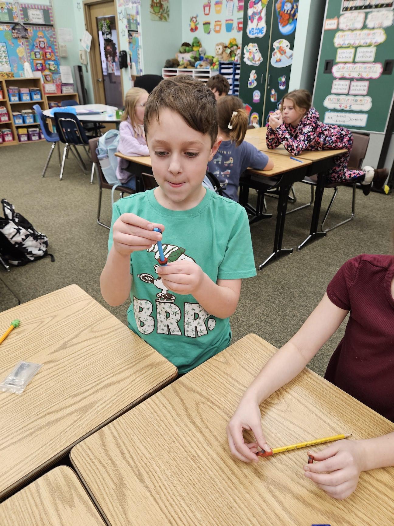 Greyson Koloski observes how magnets repel each other