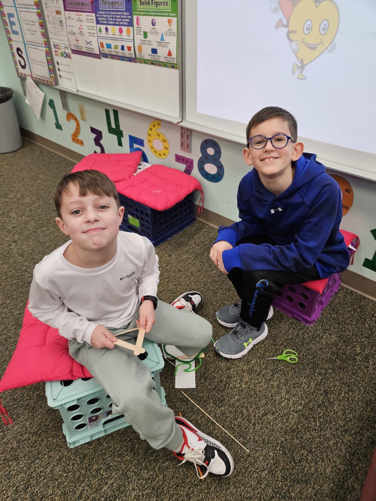 3rd-graders Lucas Antonucci and Greyson Koloski build their bow