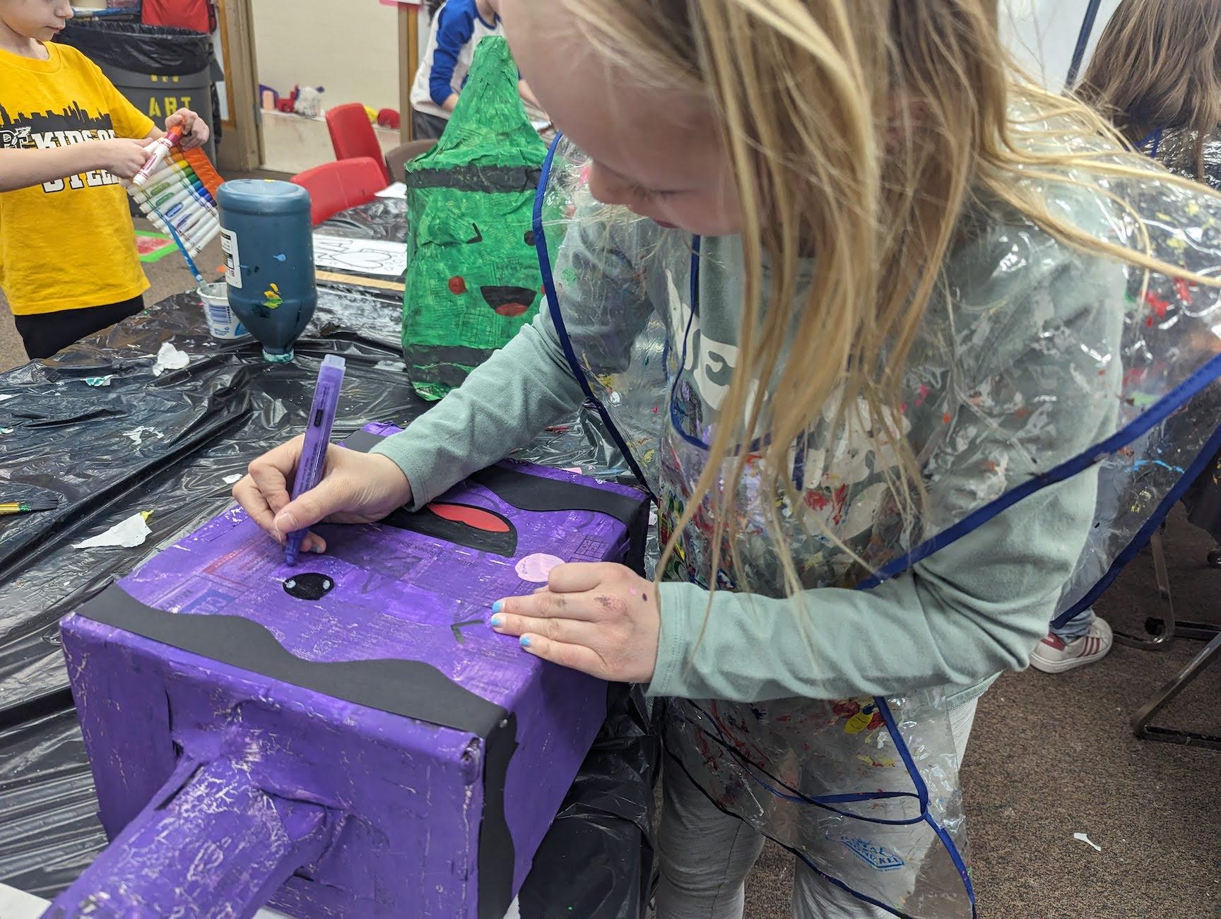 3rd-grader Avery Simmons adds some finishing touches