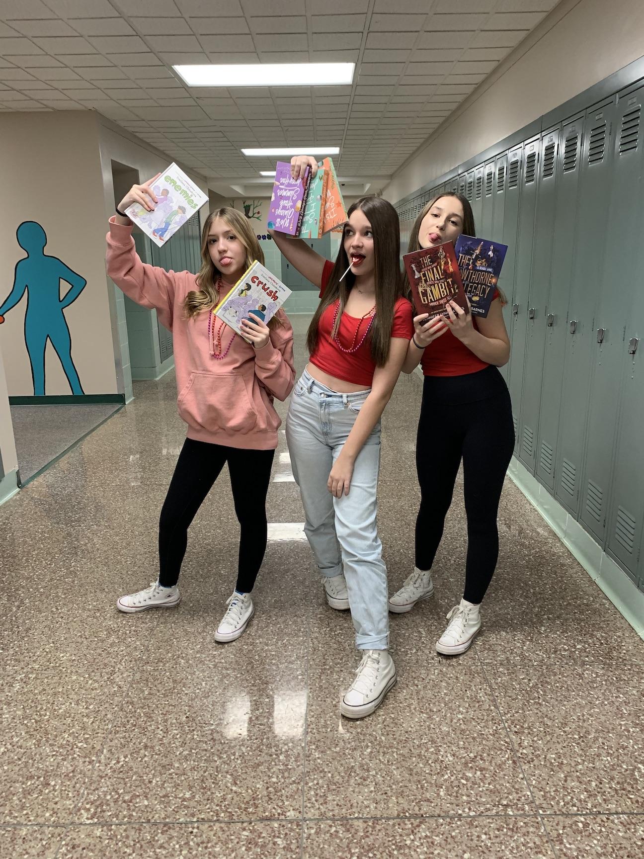 Lily Alfieri, Lily Barrett, and Ashley Hetrick show off some of the new books