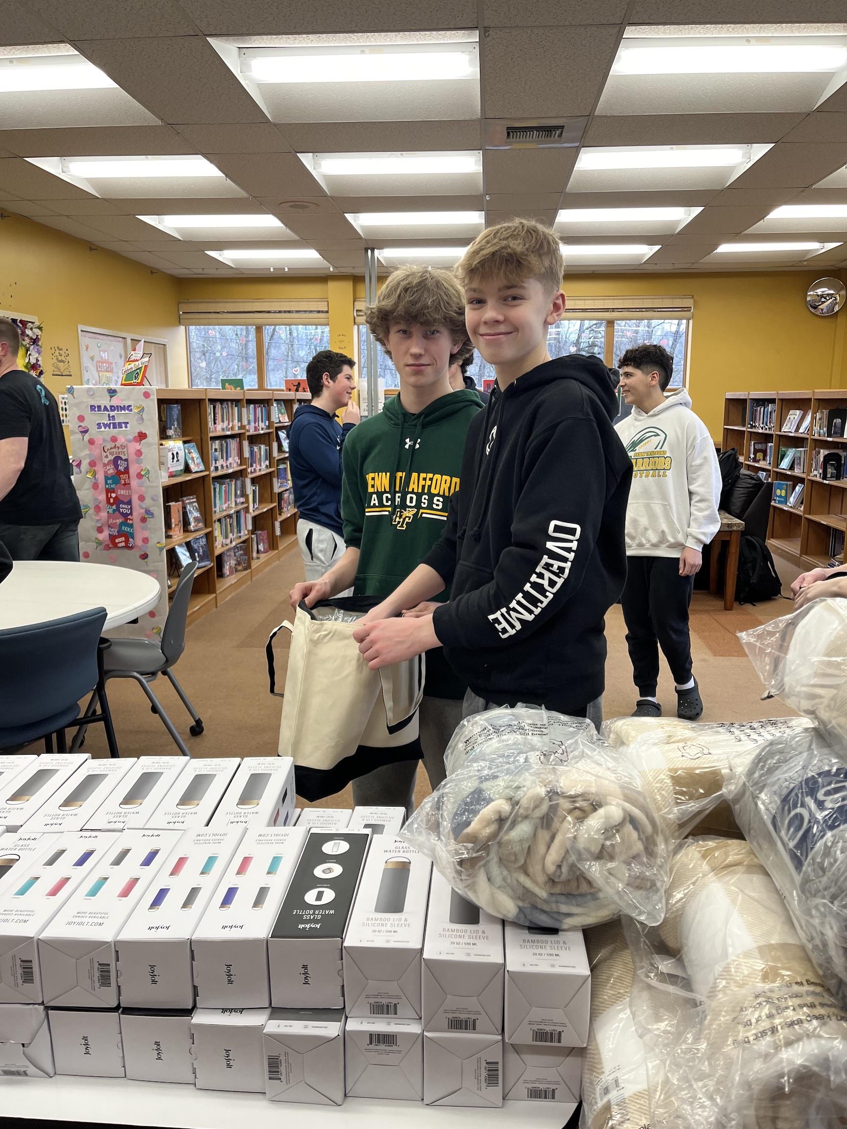 7th-graders Trey Miller and Owen Hodge work on the assembly line